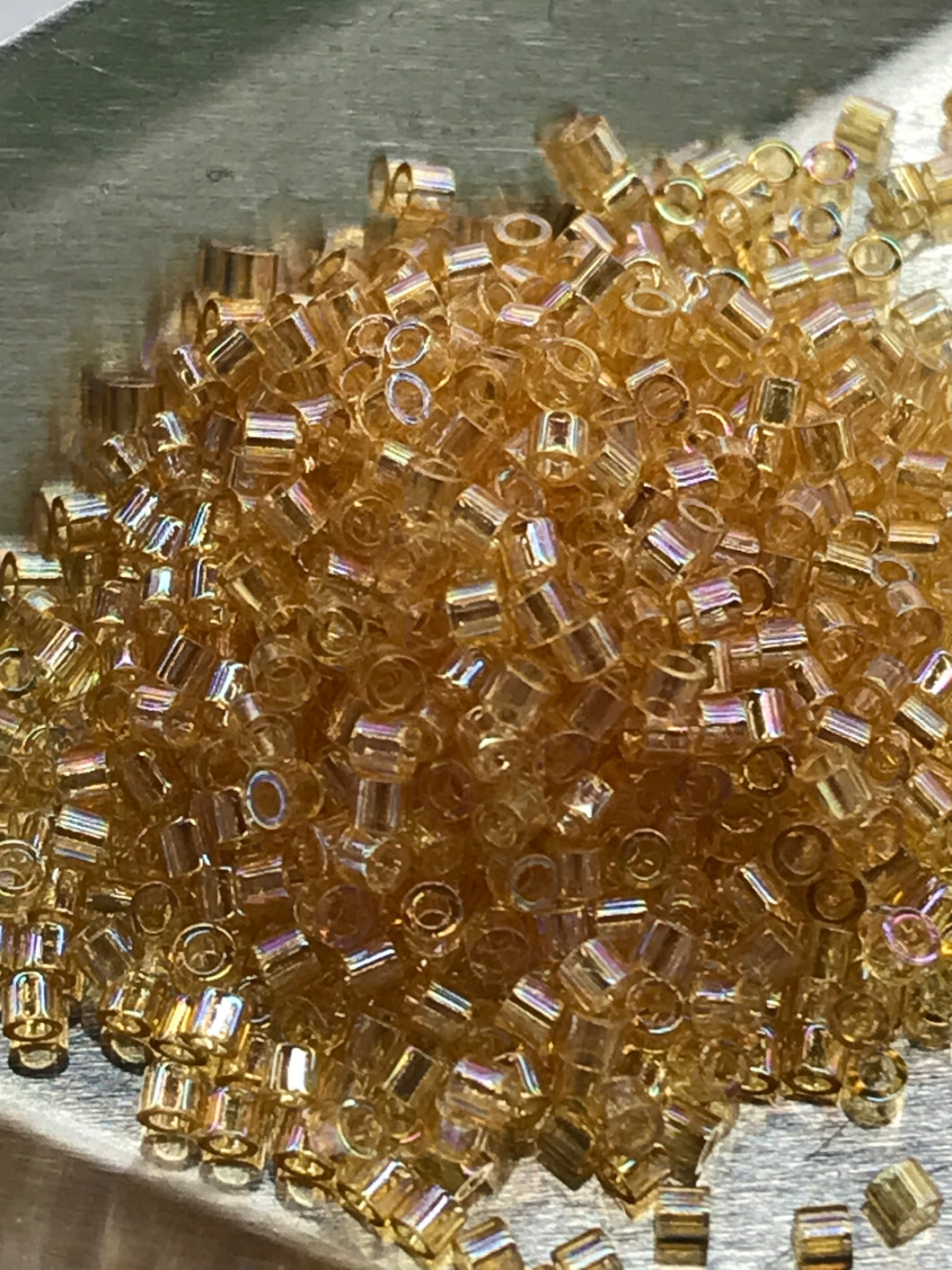 MIYUKI DELICA 15/0 LT AMBER TR AB 0100