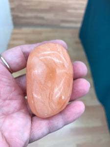 ORANGE TWIST CALCITE PALM STONE