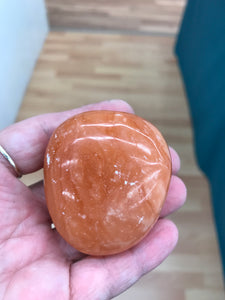 ORANGE TWIST CALCITE PALM STONE